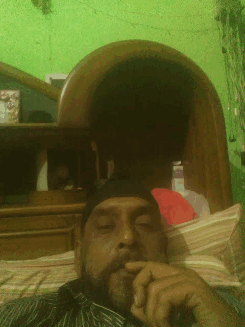 a man with a beard is laying on a bed