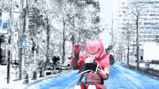a robot with a heart on his face is riding down a snowy street