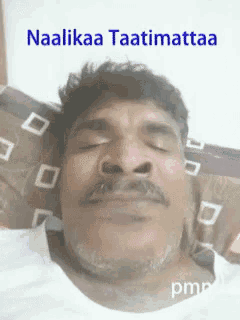 a man with a mustache is laying in bed with his eyes closed and the words naalikaa taatimattaa written above him