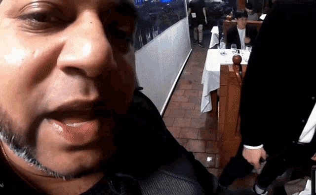 a man with a beard is taking a picture of himself