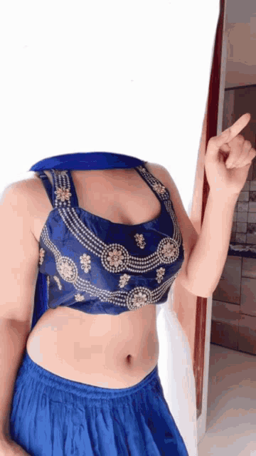 a woman without a head is wearing a blue blouse and blue skirt