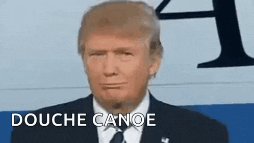 donald trump is making a funny face while giving a speech .
