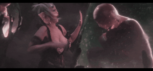 a man and a woman are standing next to each other with their hands on their faces