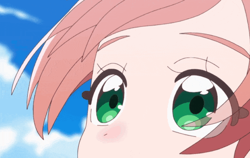 a close up of a girl 's eyes with pink hair and green eyes