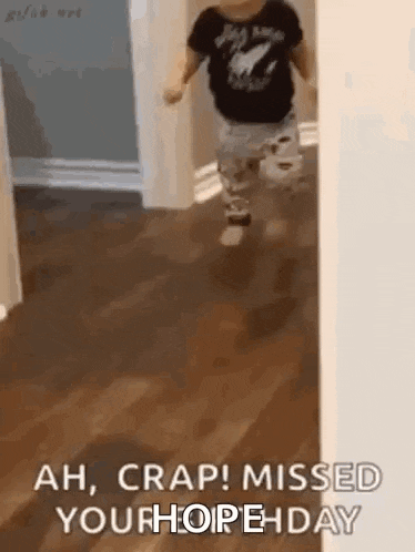 a little boy is running through a hallway .