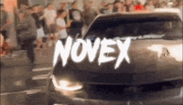 a car is driving down a street and the word novex is on the hood