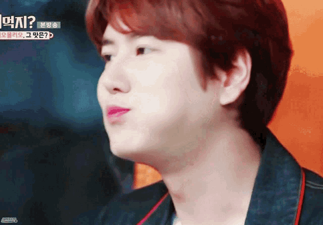 a close up of a person 's face with korean writing on the bottom right corner