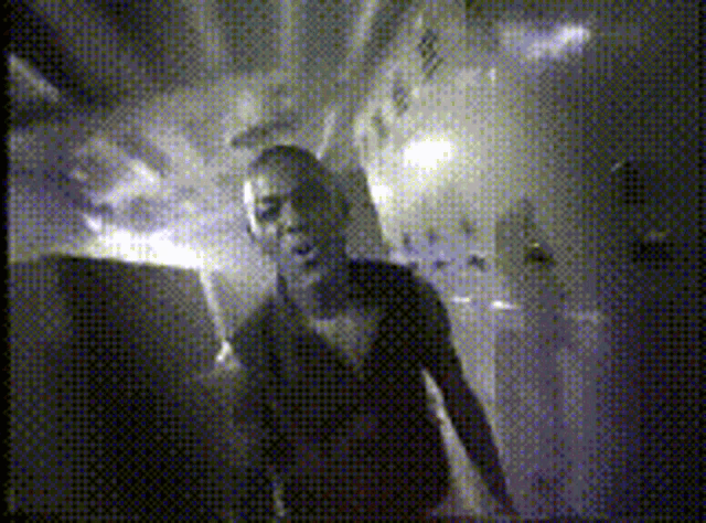 a black and white photo of a man in a room