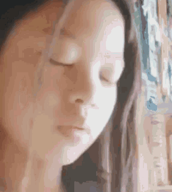 a close up of a woman with her eyes closed