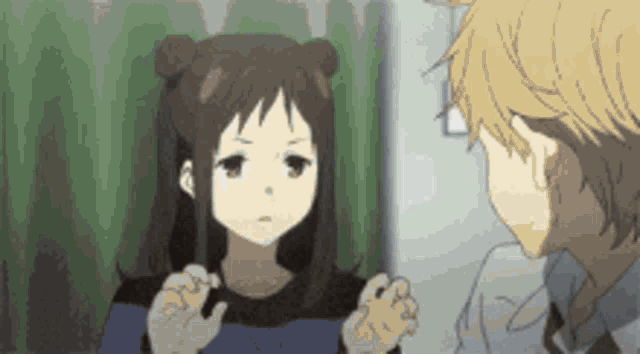 a boy and a girl are standing next to each other in a room .