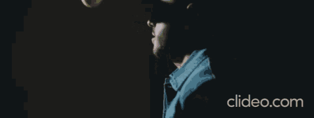 a man is throwing a tennis ball in the air and the website clideo.com is visible in the corner