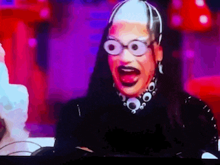 a close up of a person wearing glasses making a funny face .