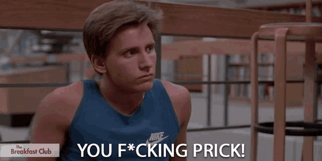 a man wearing a nike tank top says you f * cking prick