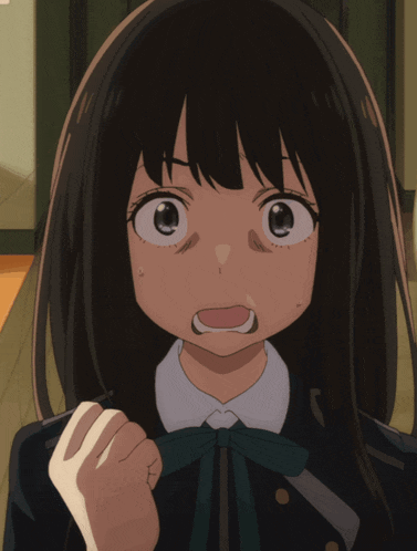 a close up of a girl 's face with her mouth open