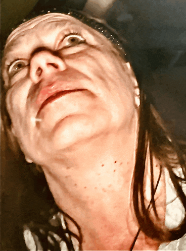 a close up of a woman 's face looking up at the camera