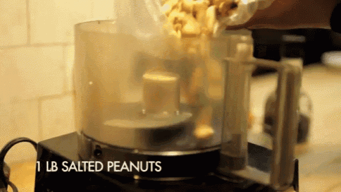 1 lb salted peanuts being poured into a food processor