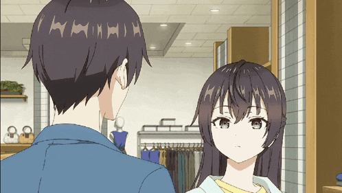 a man and a woman are looking at each other in a room