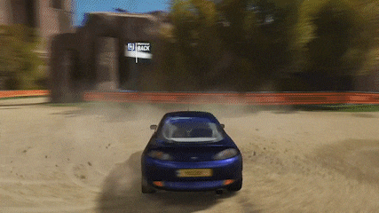 a blue car is driving on a dirt road with a sign that says track