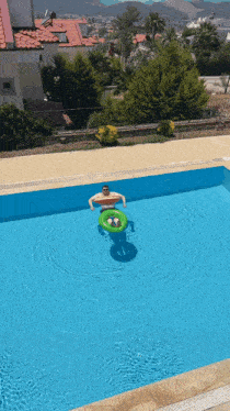 a man is floating on an inflatable in a pool