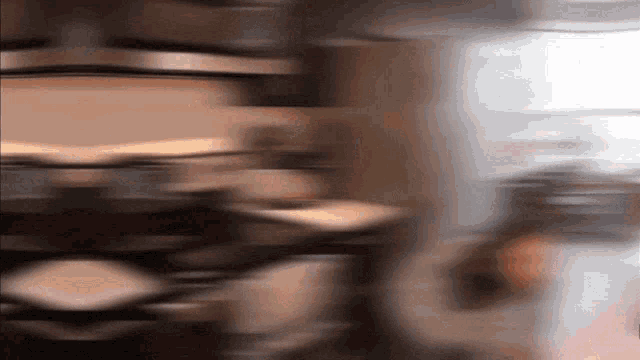 a blurry picture of a person 's face with a blurred background of a room