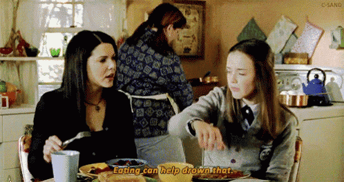 two women are sitting at a table with plates of food and one of them says eating can help shown that .