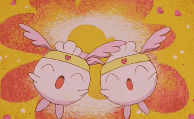 two pink cartoon characters with hearts on their faces