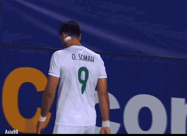 a soccer player wearing a white jersey with the number 9 on it