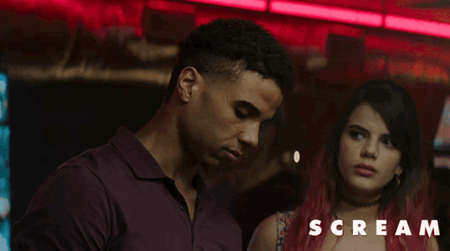 a man and a woman are standing next to each other and the word scream is below them