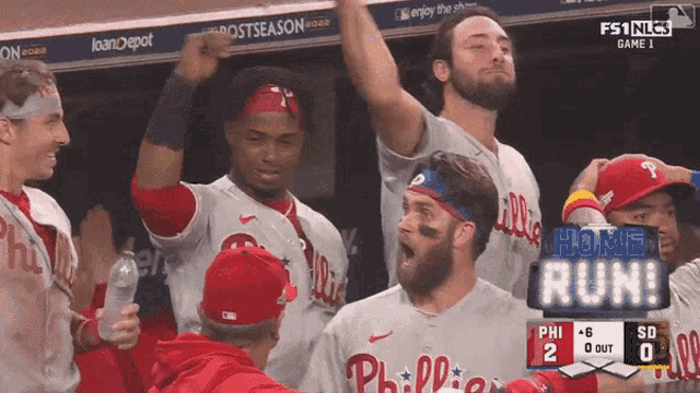 a philadelphia phillies baseball team celebrates in the dugout during a game
