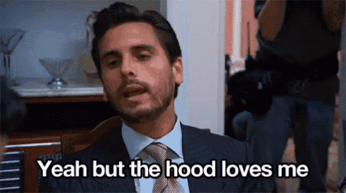 a man in a suit and tie says " yeah but the hood loves me "