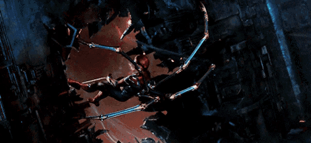 a man in a spiderman suit is hanging from a rope in a dark room