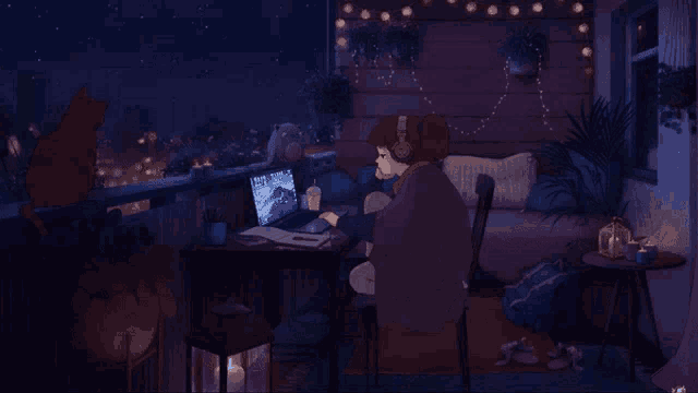 a person sitting at a desk with a laptop
