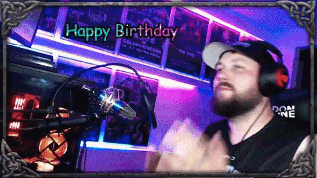 a man wearing headphones and a hat stands in front of a microphone with the words happy birthday above him