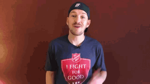 a man wearing a t-shirt that says " i fight for good "