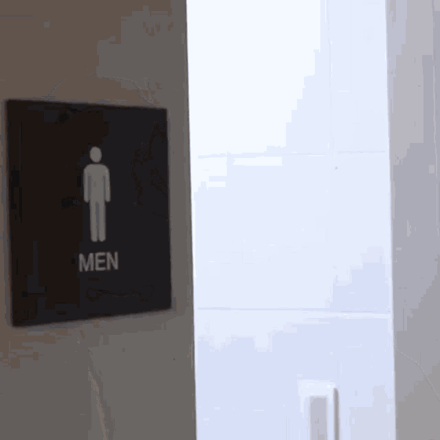 a sign for a men 's restroom with a picture of a man on it
