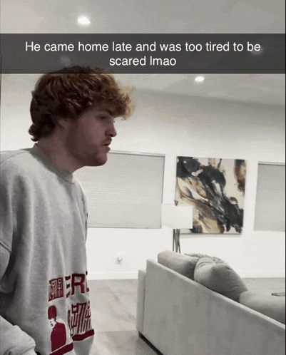 a man standing in a living room with a caption that says he came home late and was too tired to be scared imag
