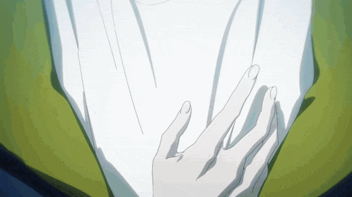 a close up of a person 's hand touching another person 's shirt