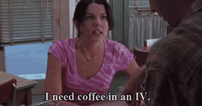 a woman in a pink shirt is sitting at a table with a man and saying i need coffee in an iv