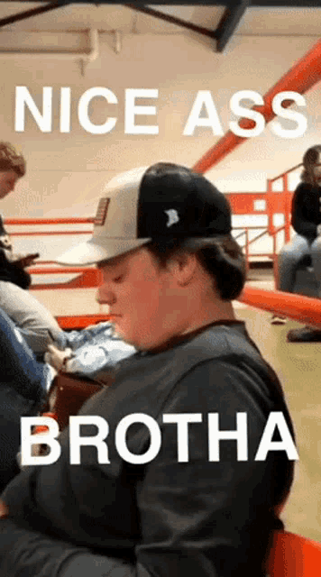 a man wearing a hat with the words nice ass brotha written on it