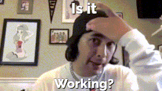 a man scratching his head with the words " is it working " behind him