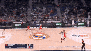 a basketball game between real madrid and olympiacos is going on