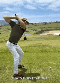 a man is swinging a golf club on a golf course and saying `` that 's how it 's done ! ''