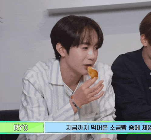 a young man eating a donut with the name ryo on the bottom