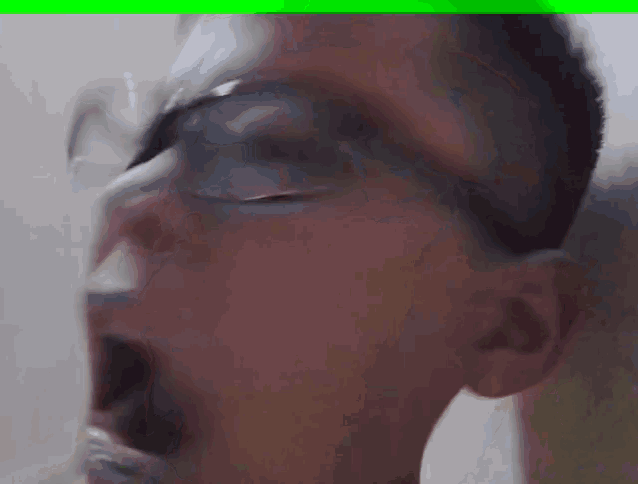 a man wearing glasses with his mouth open