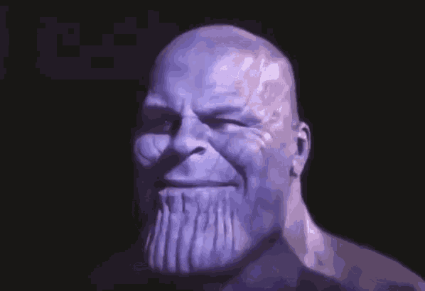 thanos from avengers infinity war is making a funny face with his mouth open and his hand on his chin .