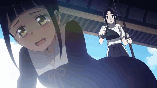 a girl with a bow and arrow stands next to another girl with a bow and arrow
