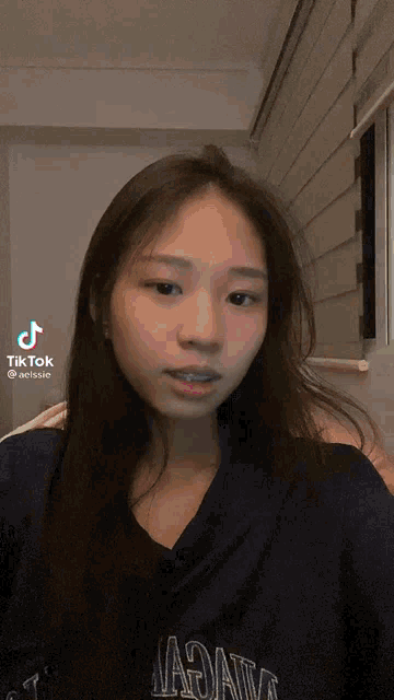 a girl with braces on her teeth is wearing a shirt that says nagata on it