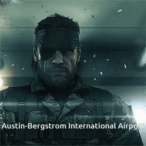 a man in a military uniform stands in front of a sign that says austin bergstrom international airport