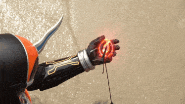 a person wearing a helmet and a glove with a red glowing object on it