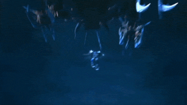 a robot is flying through the air with a blue light coming out of it .